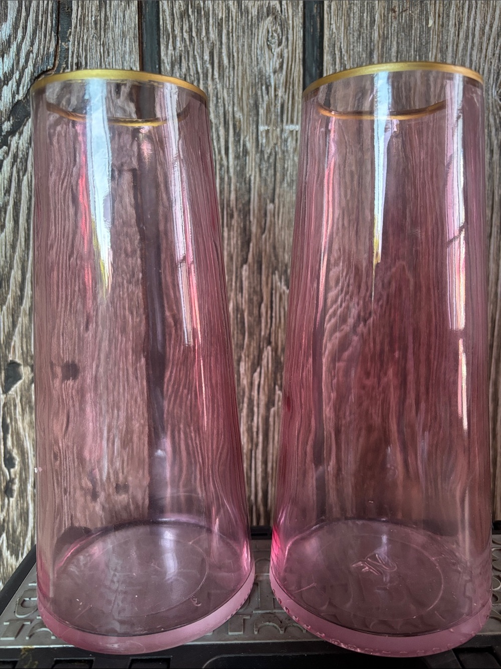 2 pink vases with gold rims